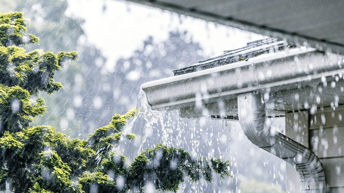 Roof plumbing working hard in storm. Large amounts of water sheet across the roof and the gutters work hard to direct the water way from the homes foundations and towards the soak wells.