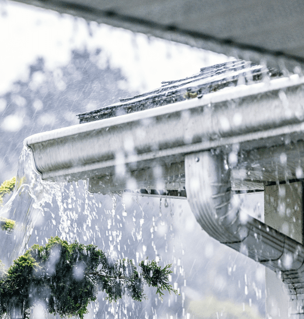 Roof plumbing working hard in storm. Large amounts of water sheet across the roof and the gutters work hard to direct the water way from the homes foundations and towards the soak wells.